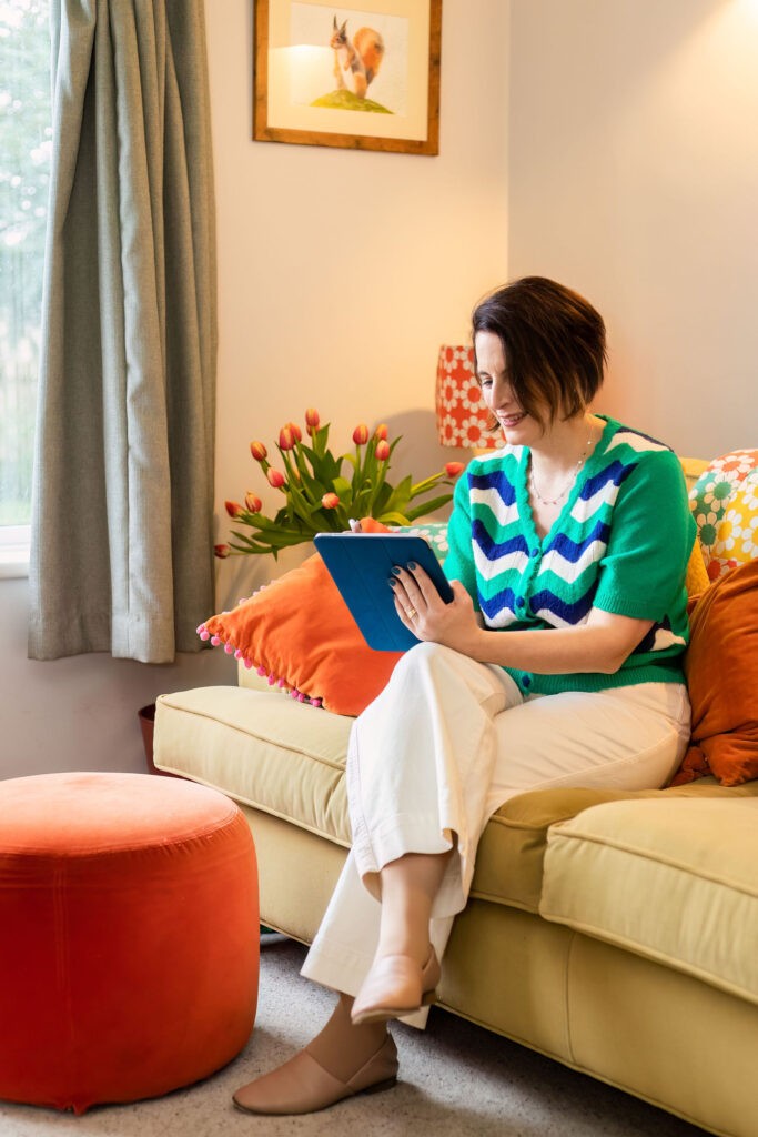 Alison Ellerbrook sitting on sofa